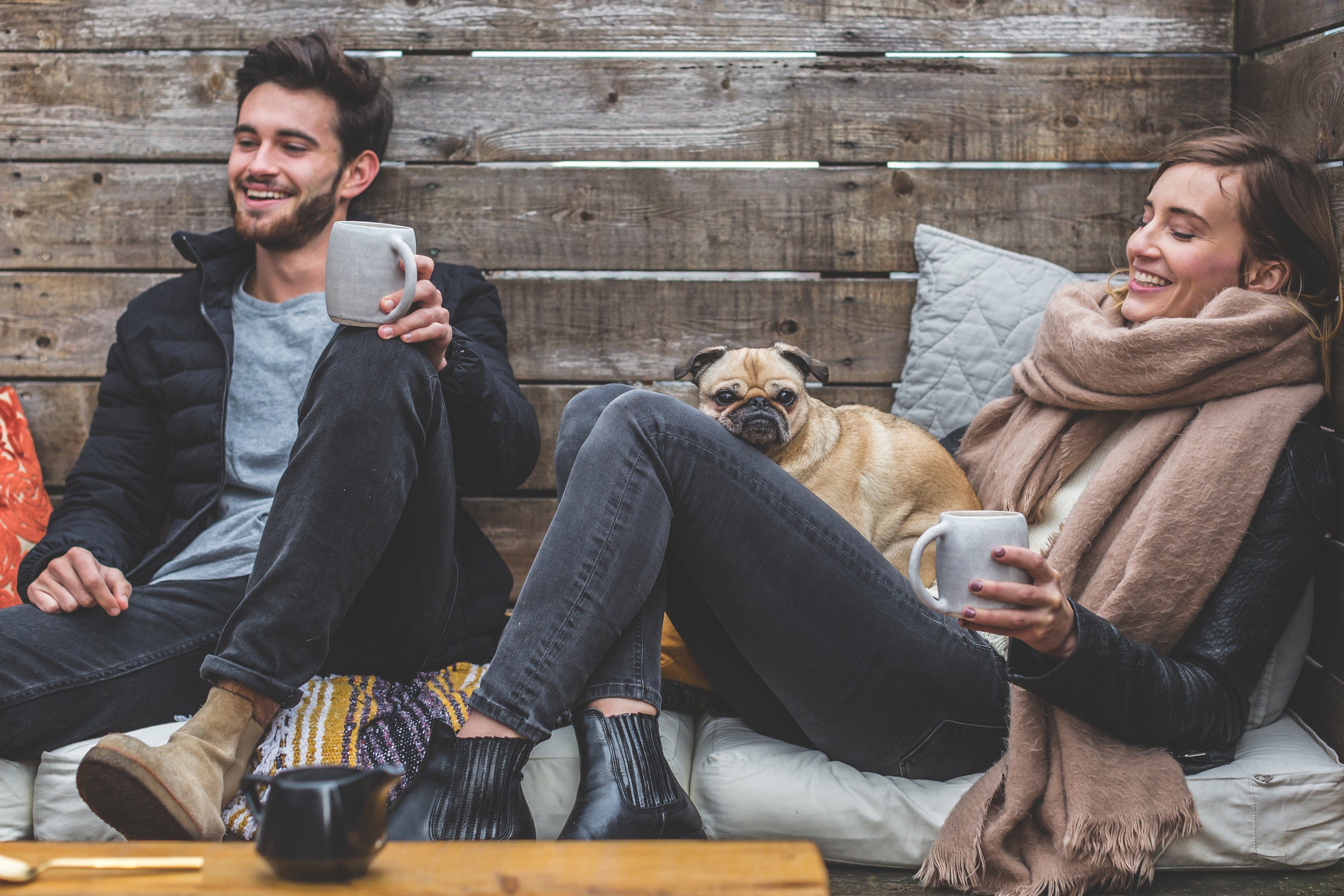 smiling man and woman with pug